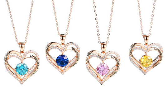 Four rose gold heart birthstone necklaces in aquamarine blue, sapphire blue, pink and yellow stones