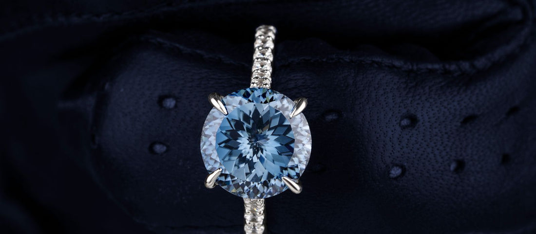 Sparkling aquamarine ring set with diamonds against a dark backdrop