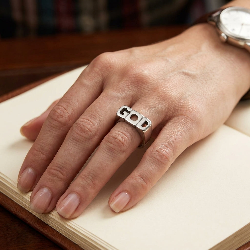 Model wearing the stainless steel men's ring engraved with G O D