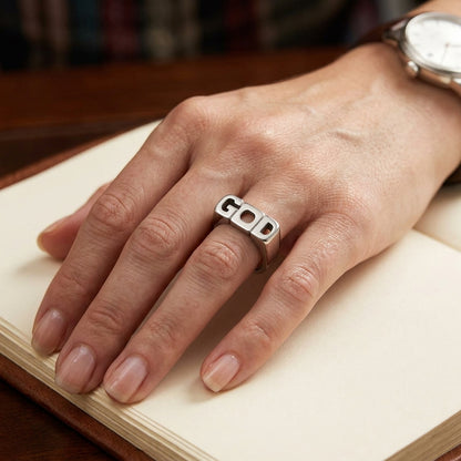 Model wearing the stainless steel men's ring engraved with G O D