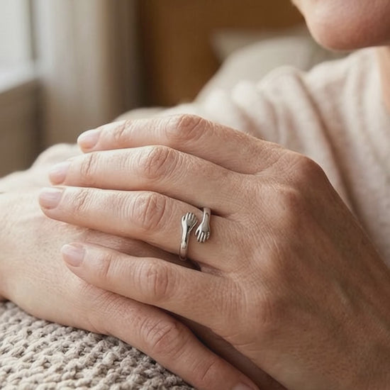 Short video of a hand wearing the Hug from Heaven Ring, a ring with two hands hugging
